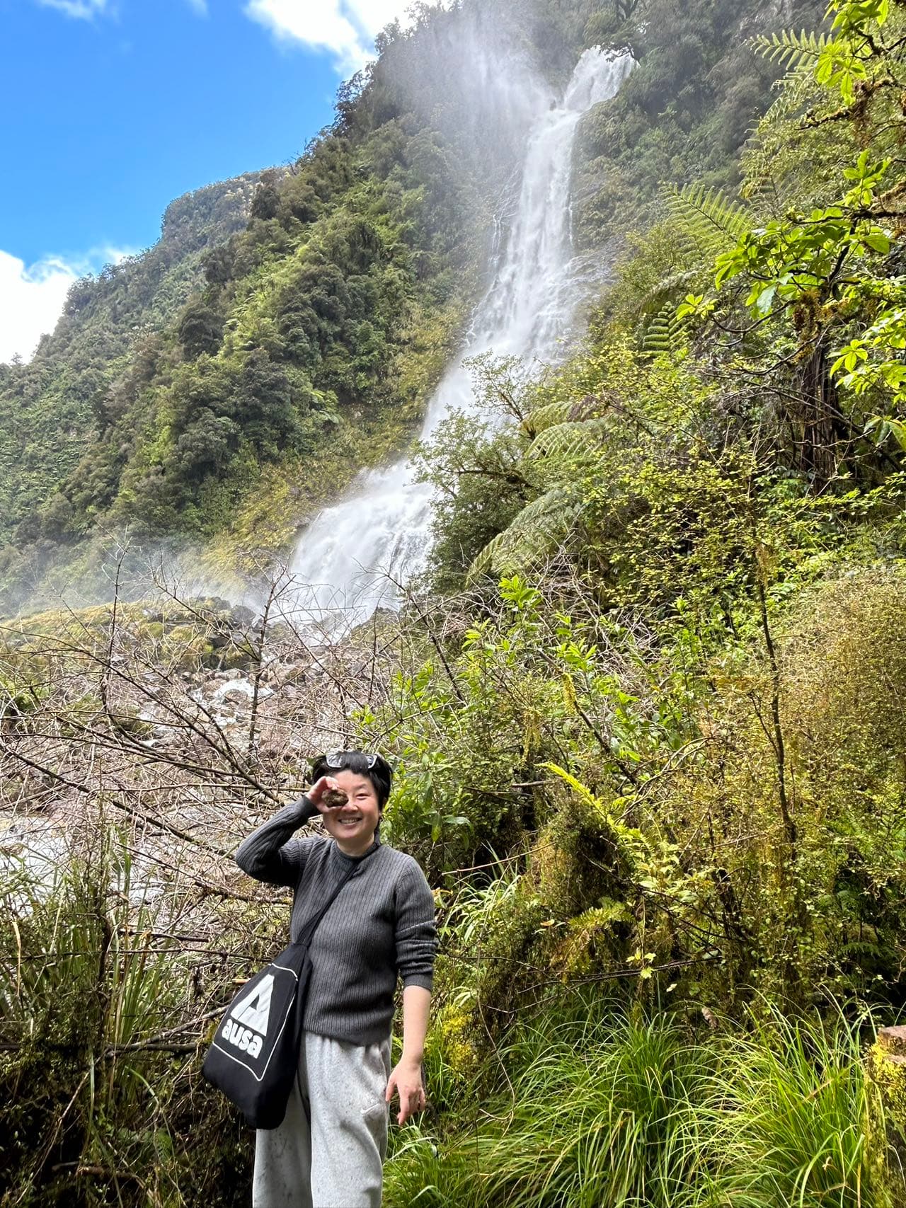 Me at the waterfall with the stones I collected